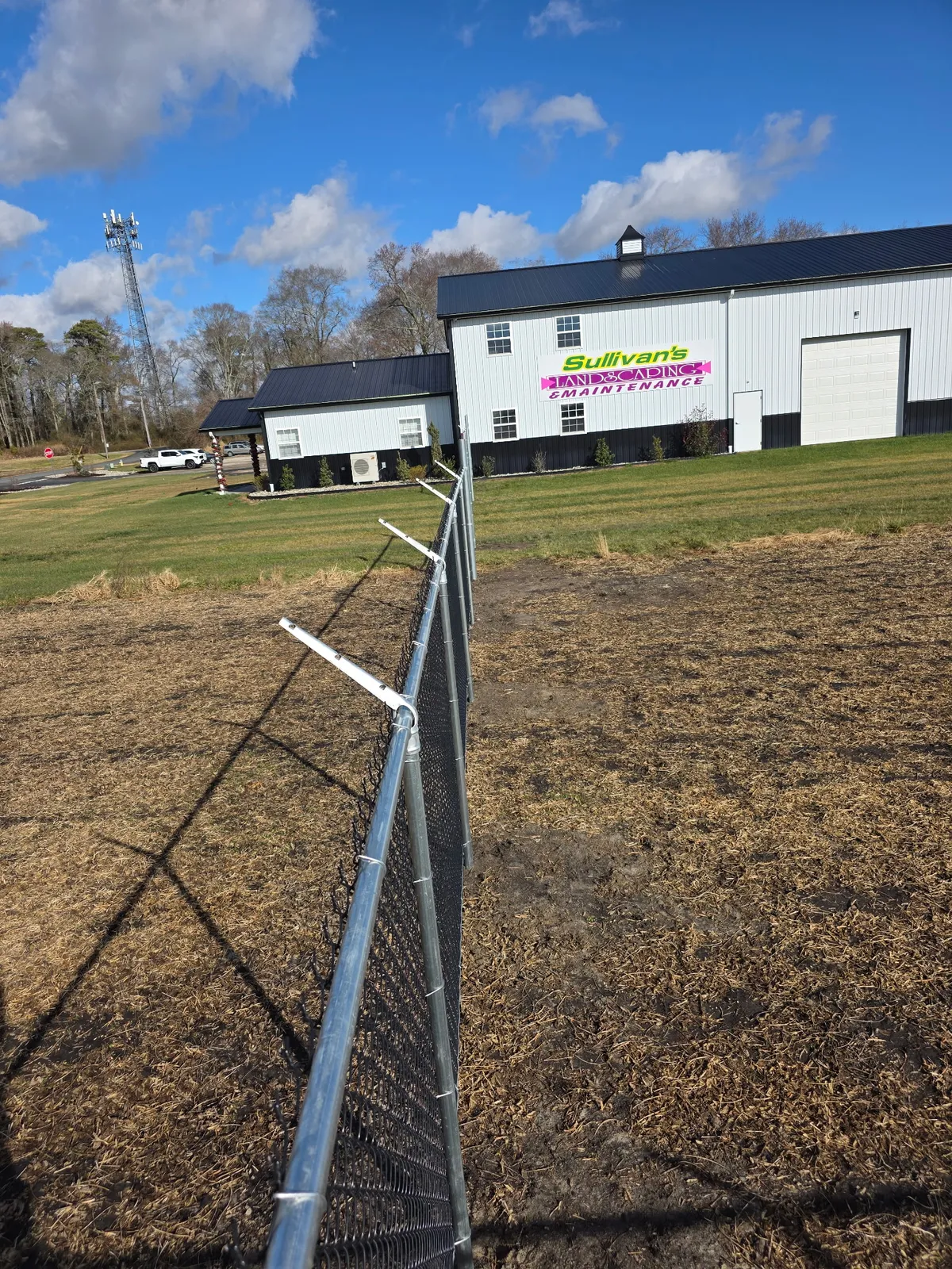 Commercial chain link fence with barbed wire on business property